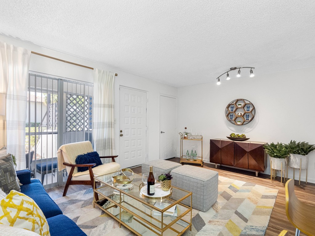 A living room with a blue couch and a yellow chair.